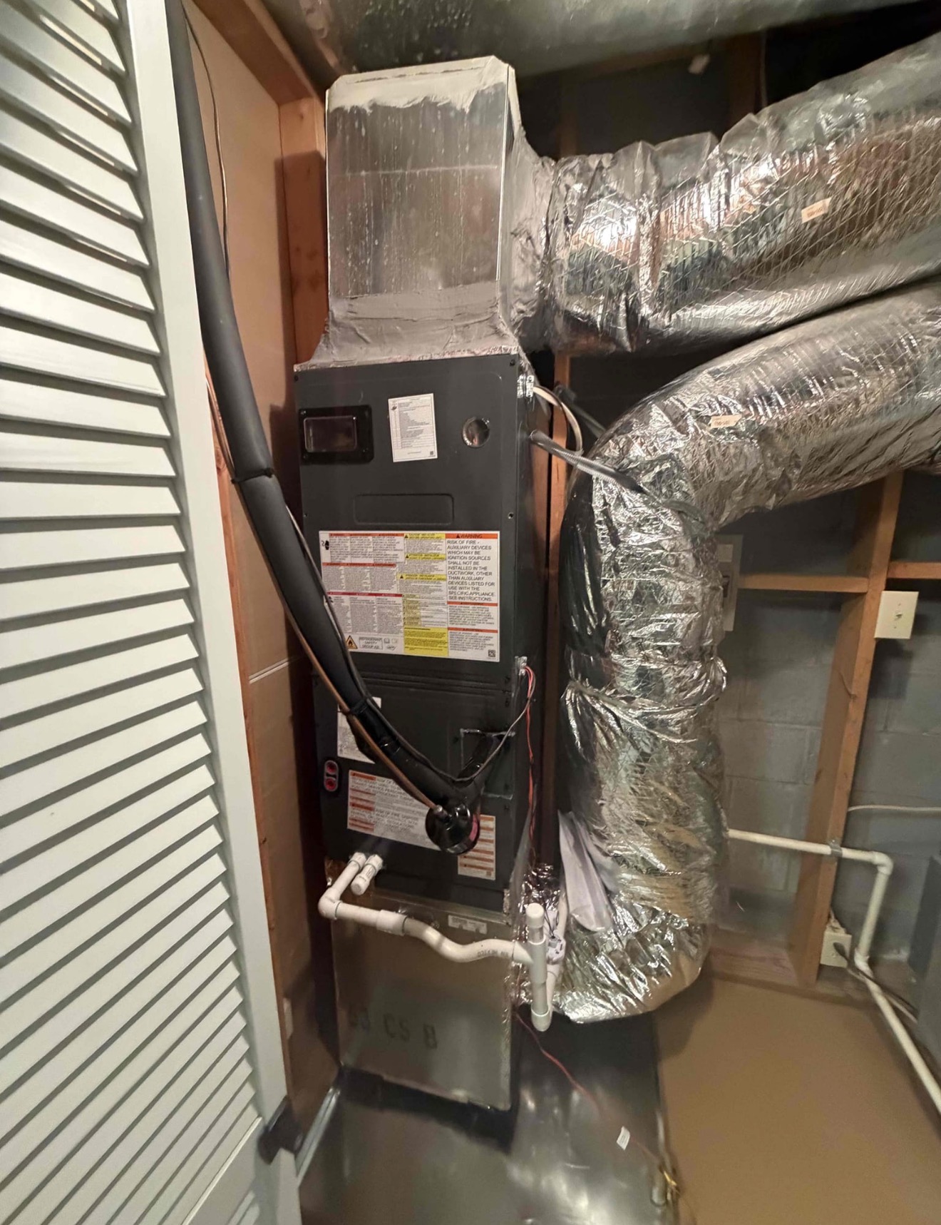 Air handler installation in closet configuration with proper insulated line set, sealed ductwork connections, PVC condensate drainage, installed per manufacturer requirements