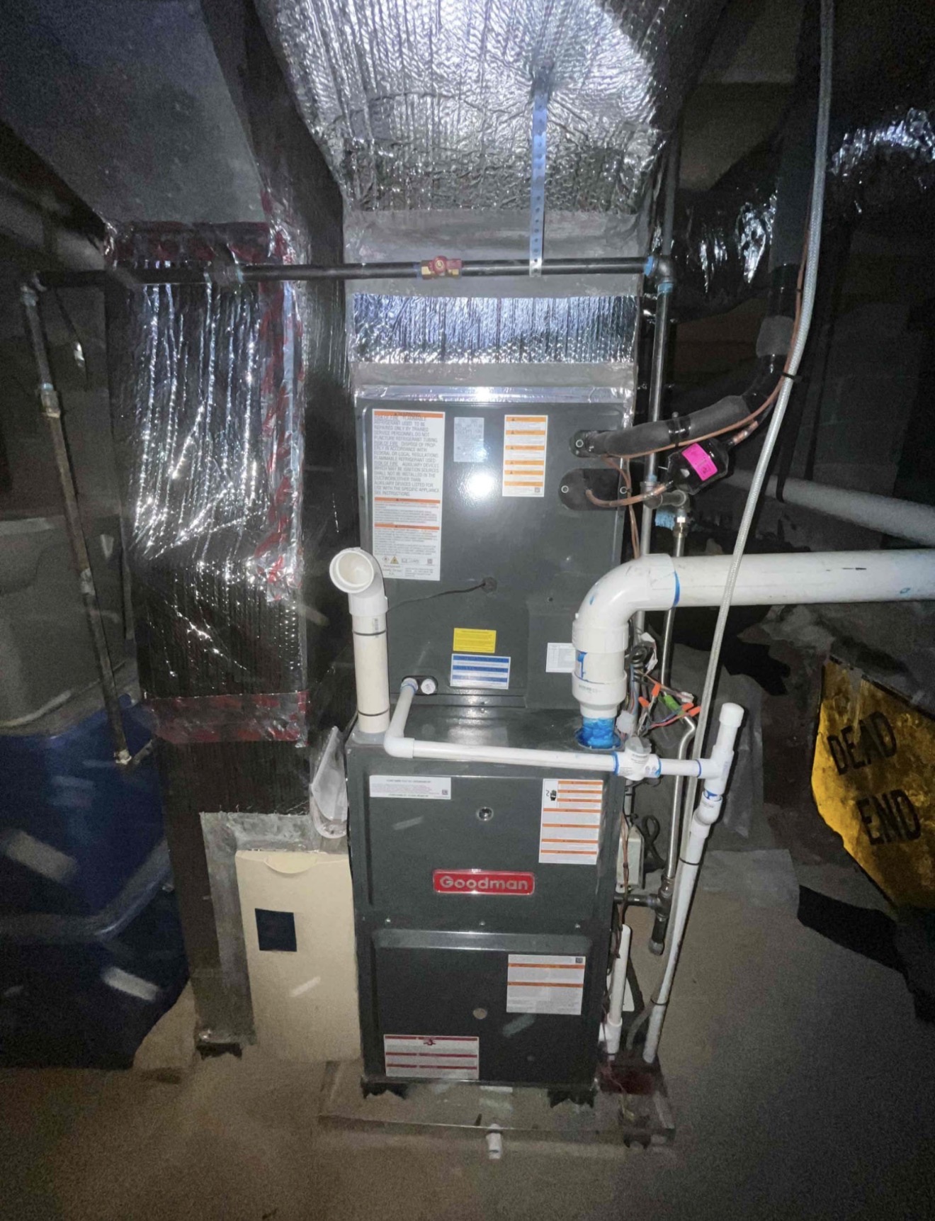New Goodman high-efficiency gas furnace installed with proper PVC venting, clean condensate drain lines with proper trap, new evaporator coil with sealed connections
